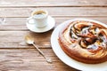 Sweet chocolate cake. Delicious chocolate cake in white plate with cup of coffee on wooden table background, close-up Royalty Free Stock Photo