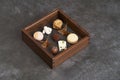 Sweet chocolate candies in wooden box, close-up. A set of assorted chocolates Royalty Free Stock Photo