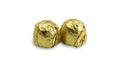 Sweet chocolate candy wrapped In golden foil papper on white background. Royalty Free Stock Photo