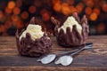 Sweet chocolate dessert with vanilla cream and chocolate hearts on wooden background with lights, product photography for patisser Royalty Free Stock Photo