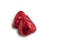 Sweet chocolate heart shaped candy wrapped in red foil papper on white background. Royalty Free Stock Photo