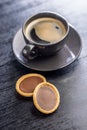 Sweet chocolate tartelettes and coffee cup on black table Royalty Free Stock Photo
