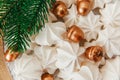 Sweet christmas background with airy meringues ,fir branch,golden acorns