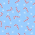 Sweet Christmas candy with snowflakes, seamless pattern on blue texture