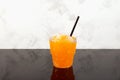 Sweet citrus Shaved ice. Orange Granizado in disposable plastic take away cup. Refreshing Slushie drink Royalty Free Stock Photo