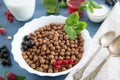 Sweet Cocoa Chocolate Sugar Cereal Puffs with Milk Healthy tasty breakfast chocolate balls with strawberries Royalty Free Stock Photo