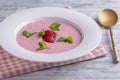 Sweet cold strawberry soup with green mint leaf in a white bowl on wooden table, closeup Royalty Free Stock Photo