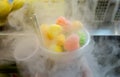 Sweet colored candies with steam of nitrogen liquid