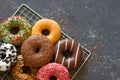 Sweet colorful donuts on dark background