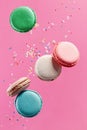 Sweet colorful French macaron biscuits on pink background