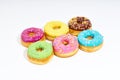 Sweet colorful glazed doughnuts on white background. Junk food top view, sugar treat