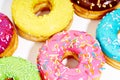 Sweet colorful glazed doughnuts on white background. Junk food top view, sugar treat