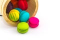 Sweet and colourful french macaroons or macaron stack in bucket wooden isolated on white background