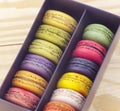 Sweet and colourful macaroons on wood
