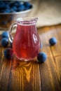 Sweet compote of autumn blue plums in a glass decanter