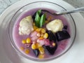 sweet compote made of starchy fruits (purple sweet potato, durian and corn) stewed in coconut milk and sugar