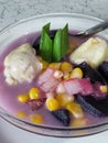 sweet compote made of starchy fruits (purple sweet potato, durian and corn) stewed in coconut milk and sugar