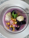 sweet compote made of starchy fruits (purple sweet potato, durian and corn) stewed in coconut milk and sugar