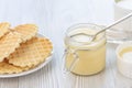 Sweet Condensed or evaporated milk and waffles on a table. Royalty Free Stock Photo