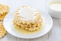 Sweet Condensed or evaporated milk and waffles on a table. Royalty Free Stock Photo