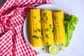 Sweet corn food with salad vegetable lime coriander and lettuce, ripe corn cobs steamed or boiled sweetcorn for food vegan dinner Royalty Free Stock Photo