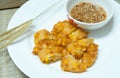 Sweet Corn Fritters,Crispy fried corn in a white plate on bamboo