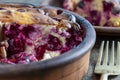 Sweet cottage cheese casserole with red cherry and semolina on wooden table. Ceramic bowl with baked cottage cheese casserole ,