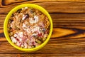 Sweet cottage cheese dessert with raspberry jam, dried fruits, grated chocolate in bowl on wooden table, top view Royalty Free Stock Photo