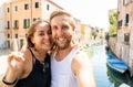 Sweet couple in love taking a selfie in Venice Italy while traveling around europe Royalty Free Stock Photo