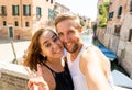 Sweet couple in love taking a selfie in Venice Italy while traveling around europe Royalty Free Stock Photo