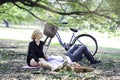 Sweet couple relaxing on picnic in park man lay down on his girlfriendÃ¢â¬â¢s lap young beautiful lover spending time together and