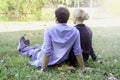 Sweet couple sitting on green grass in park young beautiful lover spending time together and having romantic moment in summer