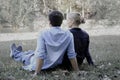 Sweet couple sitting on green grass in park  young beautiful lover spending time together and having romantic moment in summer Royalty Free Stock Photo