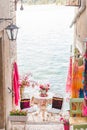 sweet cozy place table at the edge if the beach between building Royalty Free Stock Photo