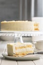 Sweet creamy cake on plate on white table Royalty Free Stock Photo