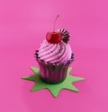 Sweet Creamy Cupcake with Topping on the pink background Royalty Free Stock Photo