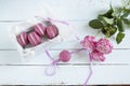 Sweet crimson french macaroons with box and hyacinth on light dyed wooden background