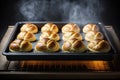 sweet crunchy buns baking in oven on baking tray