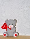 sweet cuddly teddy bear holding a heart with the inscription \