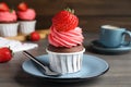 Sweet cupcake with fresh strawberry on wooden table Royalty Free Stock Photo