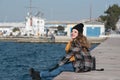 Sweet curly teen sitting on the edge of the port