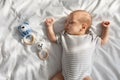 Sweet Cute Adorable Newborn Baby Sleeping On Bed Next To Rattle Toys Royalty Free Stock Photo