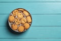 Sweet danish butter biscuits in an open tin on a turquoise wooden tabletop. Assorted crispy shortbread cookies for breakfast.