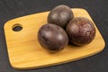 Sweet dark passion fruit on grey stone Royalty Free Stock Photo