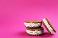 Sweet delicious ice cream cookie sandwiches on pink. Space for text Royalty Free Stock Photo