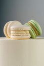 Sweet, delicious macarons are laid out as a cake topper. Cake side view, stands on the table.