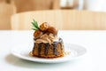 Sweet dessert and bakery concept. Macadamia toffy cake with chocolate sauce and coffee cream topped with macadamia nut and