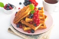 Sweet dessert belgian waffles with blueberry and red currant and tea drink Royalty Free Stock Photo