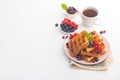 Sweet dessert belgian waffles with blueberry and red currant and tea drink Royalty Free Stock Photo