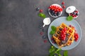 Sweet dessert belgian waffles with chocolate, blueberry and red currant Royalty Free Stock Photo